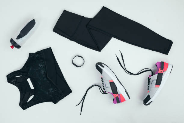 flat lay with sportswear with sneakers, fitness tracker and sports bottle isolated on grey - roupa de esportes imagens e fotografias de stock