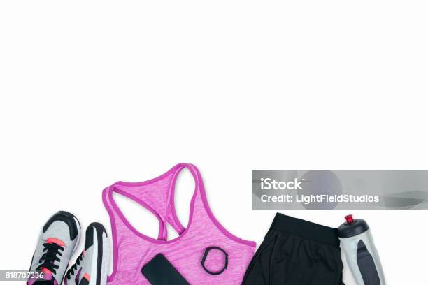 Sportswear With Sneakers Smartphone Fitness Tracker And Sports Bottle Isolated On White Stock Photo - Download Image Now