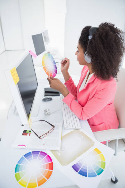 istock Casual graphic designer working at her desk 818714314
