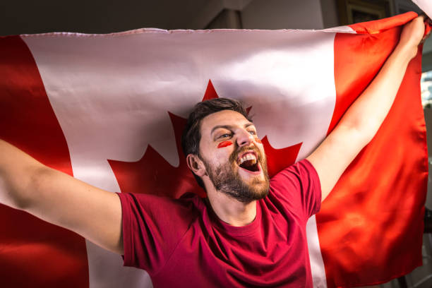 istock Canadian fan holding the national flag 818714516