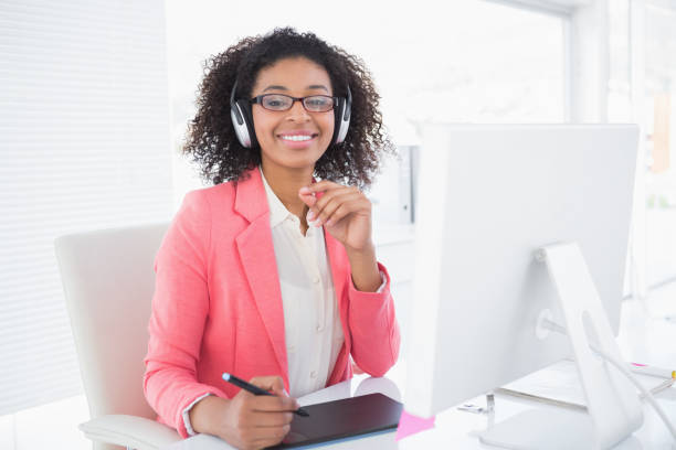 istock Casual graphic designer working at her desk smiling at camera 818716316