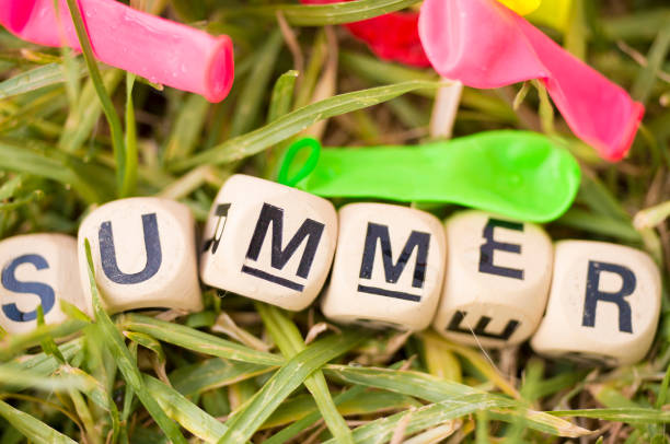 Word summer made of wooden tiles and water balloons