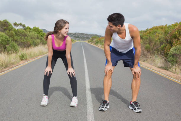 istock Couple running on the open road together 818733952