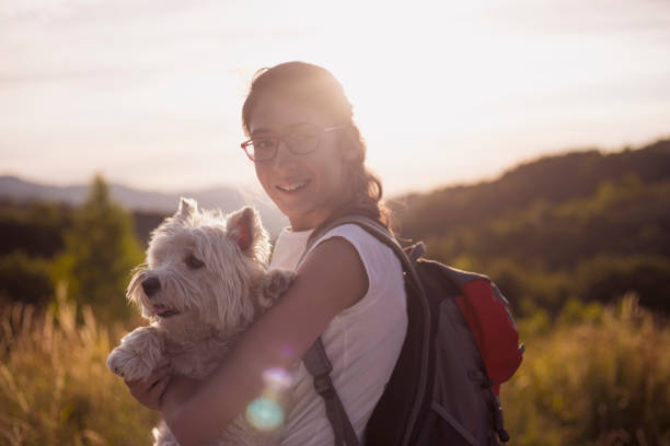 istock Smiling girl with backpack and dog 818744170