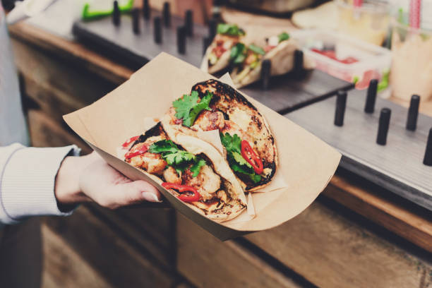 istock Street vendor hands making taco outdoors 818763004
