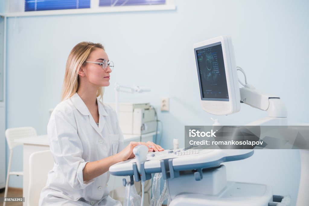 Smiling doctor, ultrasound. The doctor performed an ultrasound Sonographer Stock Photo