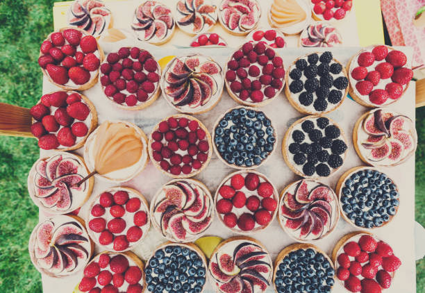 istock Fruit and Berry tarts dessert assorted top view background 818764010