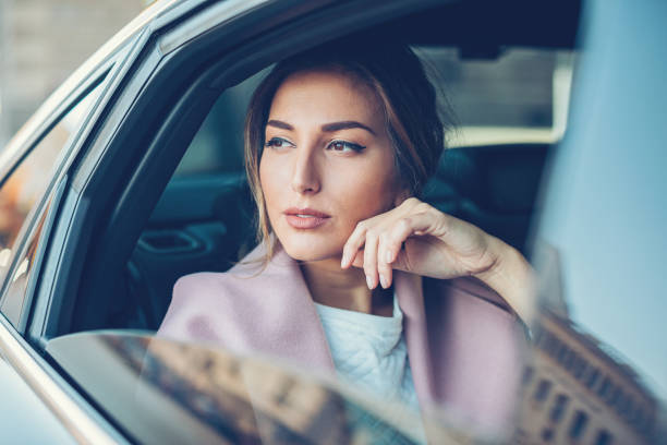 istock Beautiful woman in a car 818779684