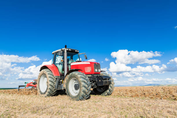 istock agricultural tractor in the foreground with blue sky background 818779994