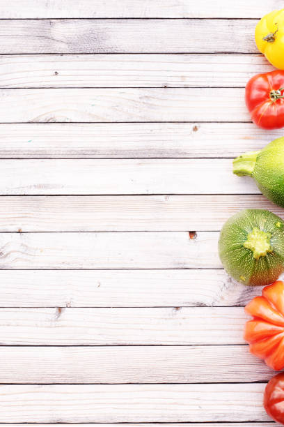 istock Vertical top view of colorful raw veggies with empty space. 818780984