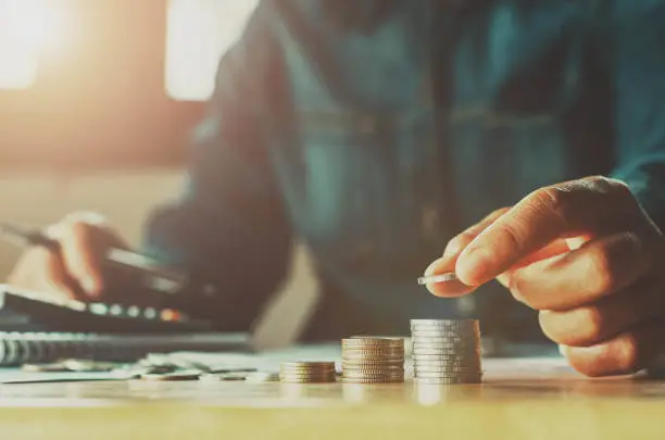 Photo of Saving money woman hand putting coin stack concept business finance