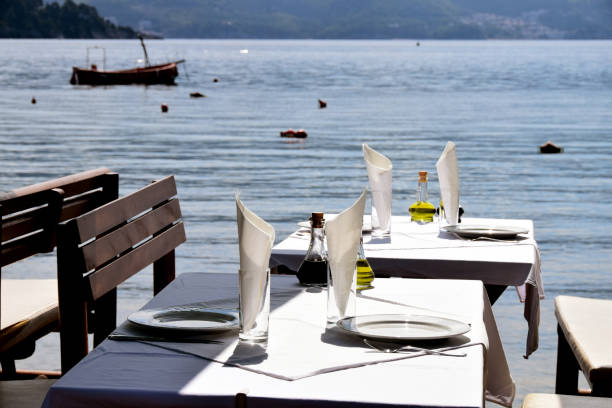 istock Table in the restaurant on the seaside, arranged for lunch 818801632
