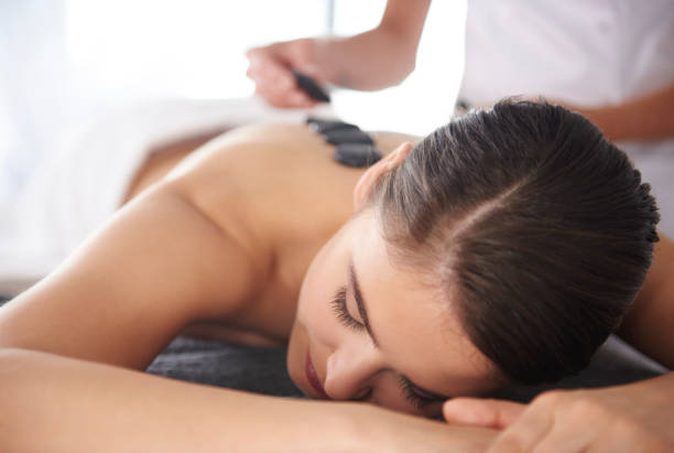 istock Woman with hot stones on the back 818807074