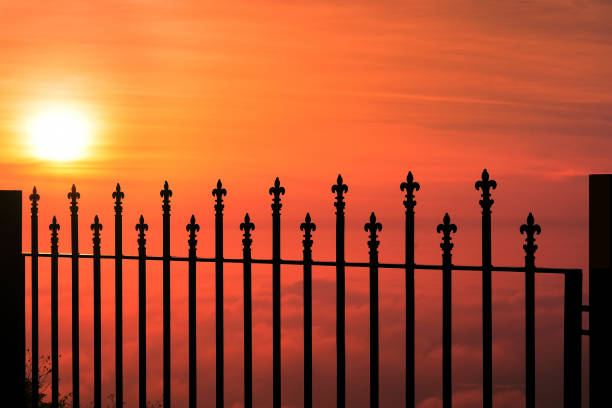 Silhouette of Wrought Iron railings against a dramatic sky at dawn Silhouette of wrought Iron railings against a dramatic red sky, the view is from top of a small hill around Bangalore called Nandi Hills fence3 stock pictures, royalty-free photos & images