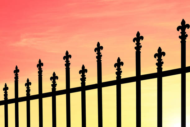 istock Silhouette of Wrought Iron railings against a dramatic sky at dawn 818814990