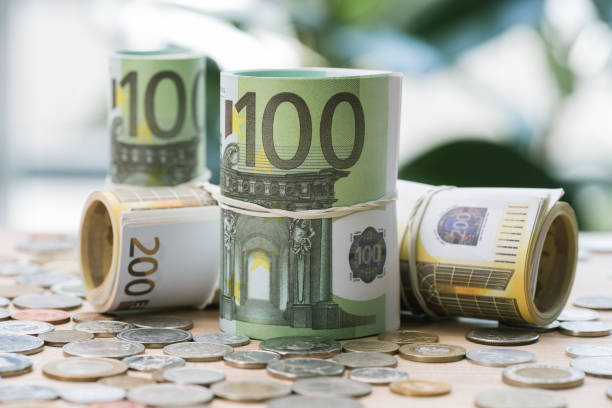 istock selective focus of euro banknotes in rolls with rubber bands and coins on table 818818180