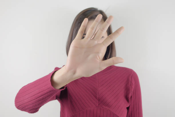 istock woman raise hand stop. business concept stop 818823856