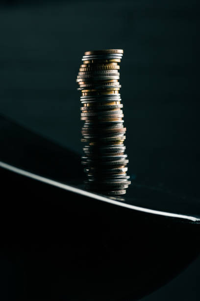 istock close up view of stack of different coins standing on edge of table 818827152