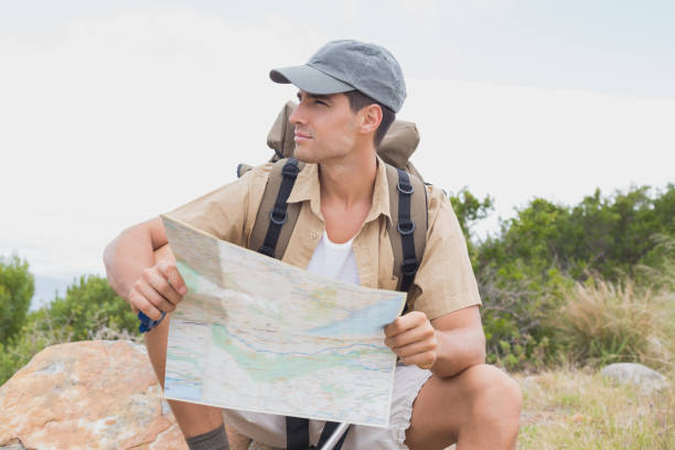 istock Hiking man sitting with map on mountain terrain 818828736