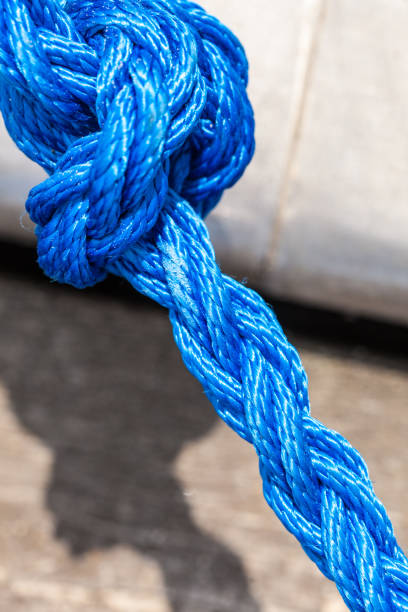 istock Blue sailing rope tied with knots 818841680