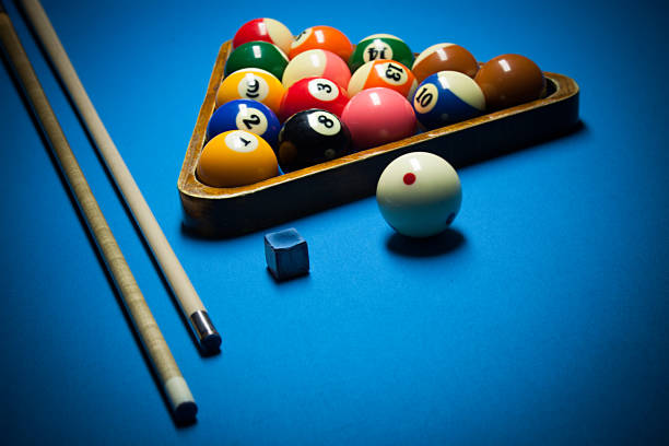 istock Image of billiard balls, cue and chalk on blue table 818849984