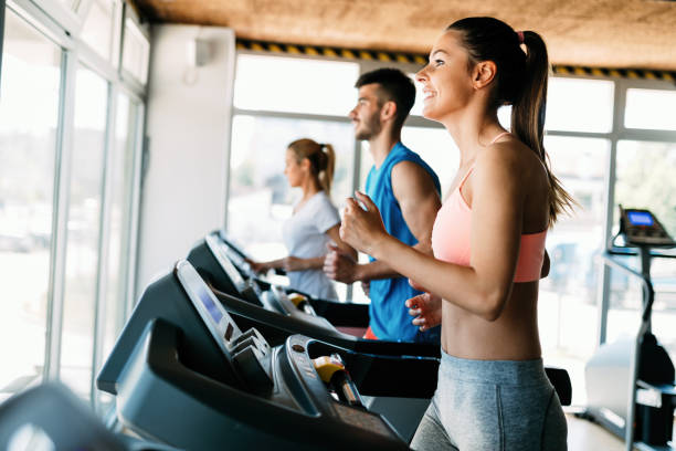 istock Group of friends exercising on treadmill machine 818875204