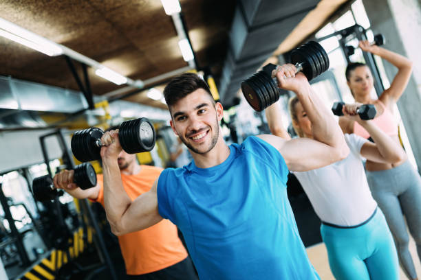 istock Group of people training together in gym 818883016