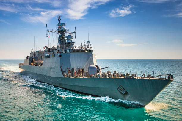grey modern warship sailing in the sea - destroyer imagens e fotografias de stock