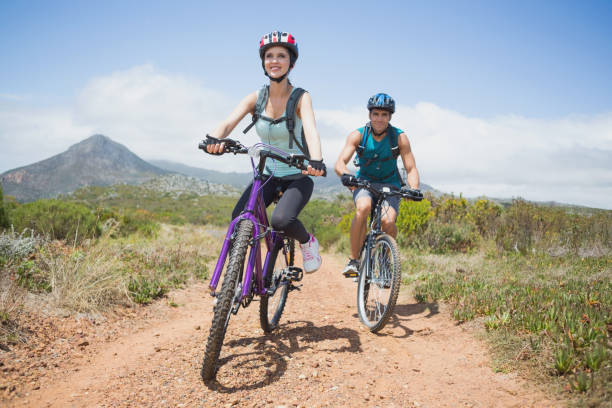 istock Athletic couple mountain biking 818889314