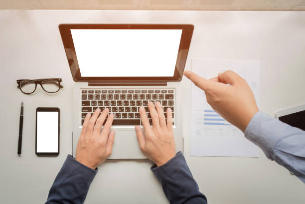 istock businessman hands working with digital tablet computer and smart phone with business graph on desk as concept. 818889758