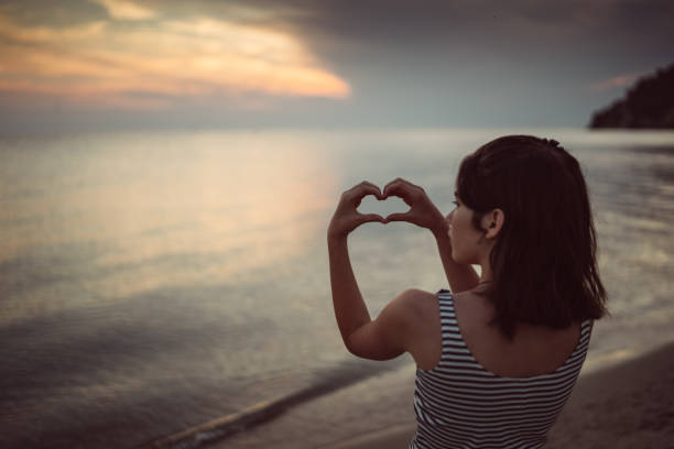 istock Little girl making heart shape with hands 818891206
