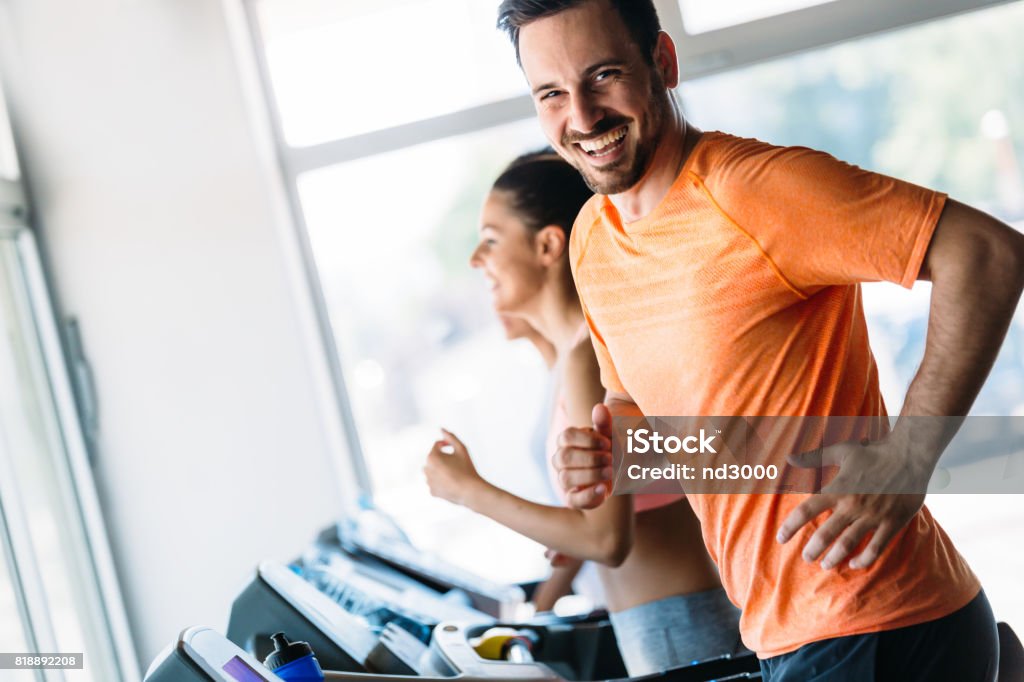 Group of friends exercising on treadmill machine Group of friends exercising on treadmill machine in gym Men Stock Photo