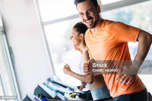 Group Of Friends Exercising On Treadmill Machine Stock Photo - Download Image Now - Men, Gym, Running