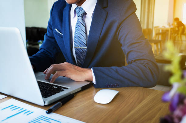 istock businessman hand working with new modern computer and business strategy as concept. 818895132
