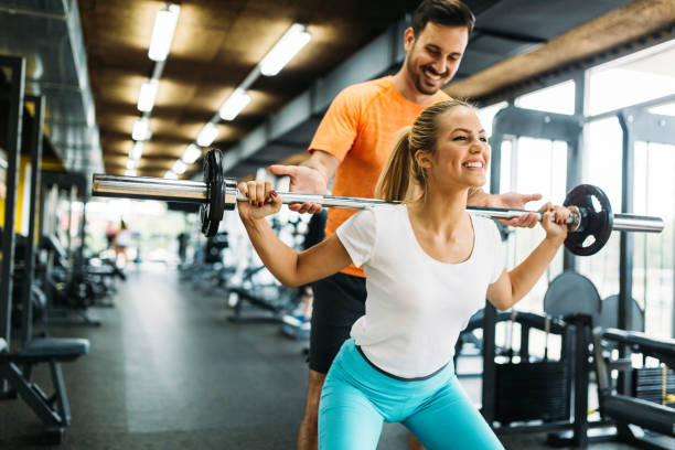istock Beautiful active woman doing squats in gym 818899584