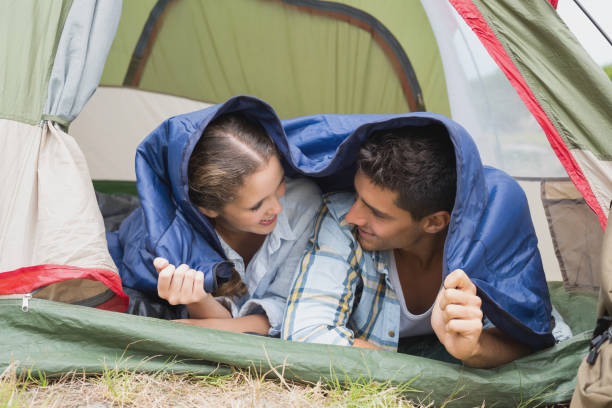 istock Happy young couple lying in tent 818900402