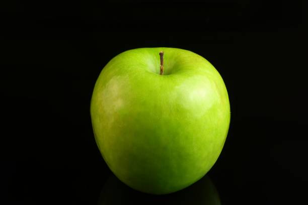 istock A fresh Granny Smith apple on a black background. 818913864