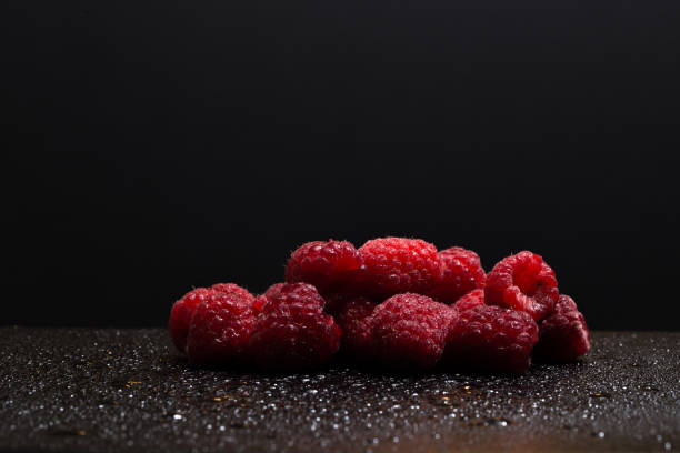 Raspberries on black background