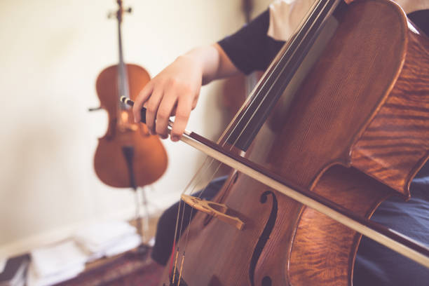 Child playing Cello Child playing Cello conservatory education building stock pictures, royalty-free photos & images