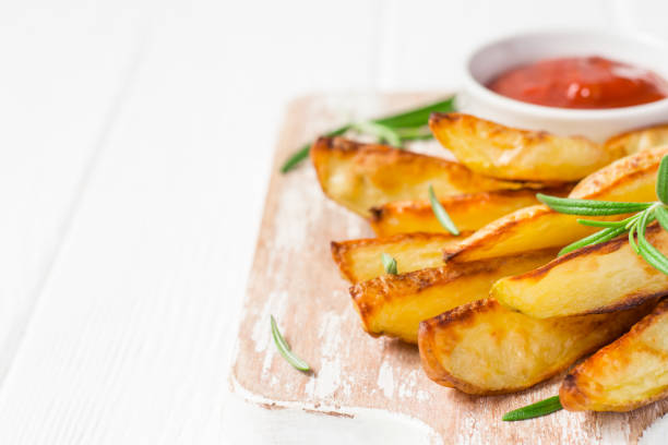 istock Baked potatoes with red sauce on white background, selective focus 818928806