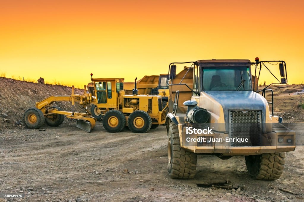 Outdoor quarry with heavy machinery Outdoor quarry with heavy machinery or road construction Construction Machinery Stock Photo