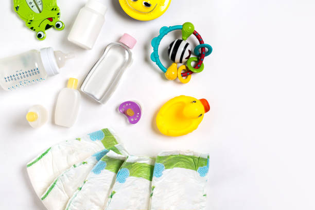 babies goods diaper, baby powder, cream, shampoo, oil on white background with copy space. top view or flat lay - equipamento de bebê imagens e fotografias de stock