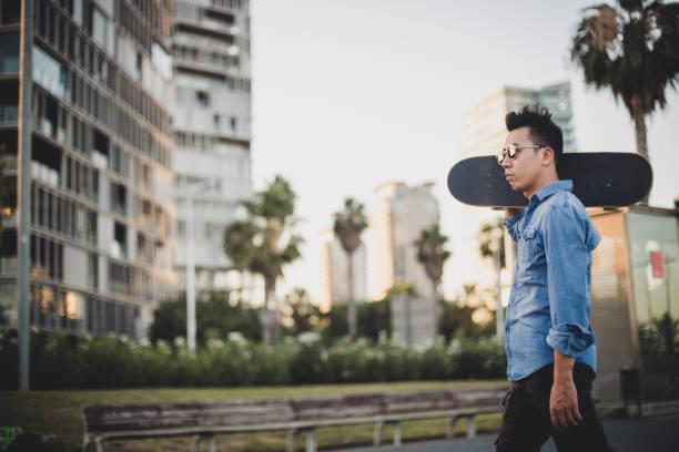 istock Chinese man carrying skateboard 818942946
