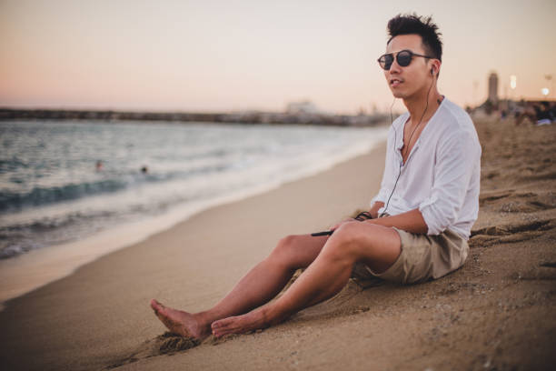 istock Chinese man sitting at the coastline 818943642