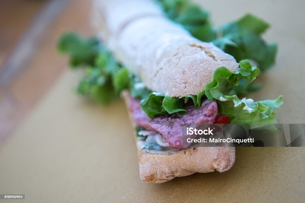Giant sandwich with sausage, salad and garlic Giant Italian sandwich with sausage, salad and garlic Street Food Stock Photo