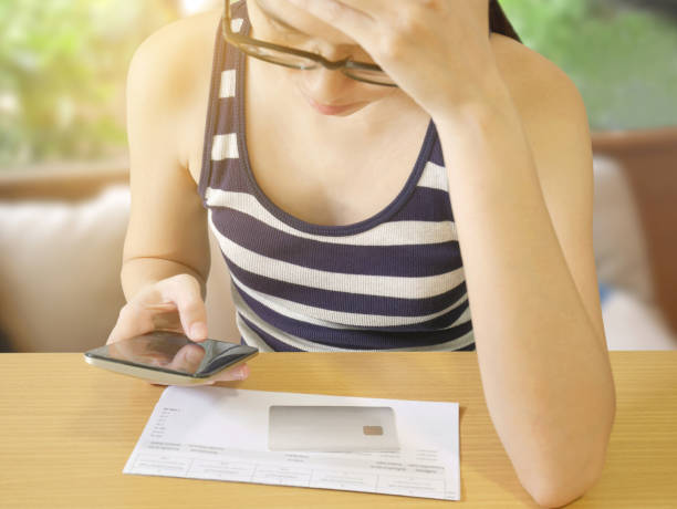 istock Woman with stress using mobile phone paying bill 818973654
