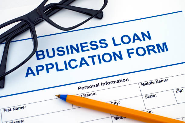 istock Business Loan Application Form with ballpoint pen and glasses. 819051572