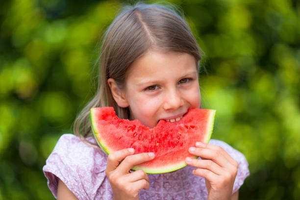 istock Little girl eating watermelon 819061516