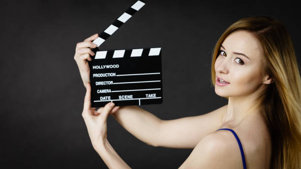 istock Woman holding professional film slate 819080486
