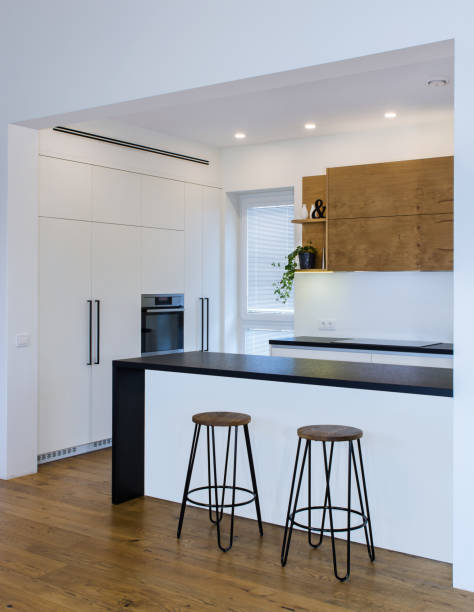 istock Modern kitchen design in light interior with wood accents. 819139448